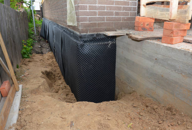 SJ Waterproofing Pros technician performing targeted Wet Basement Repair assessment in Camp Dennison, OH